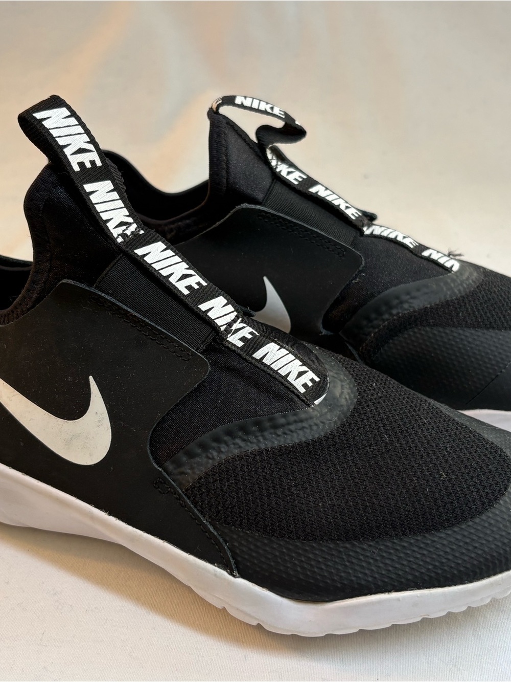 Nike Kids Black Slip-On Sneakers with White Swoosh